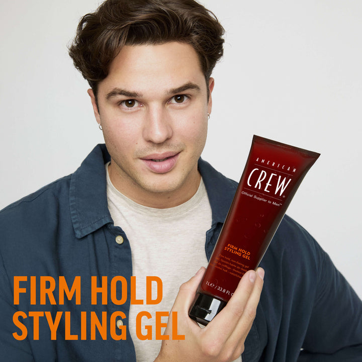 Finished Beauty Image. Dragan Mikulic Moragues holding Firm Hold Styling Gel by American Crew